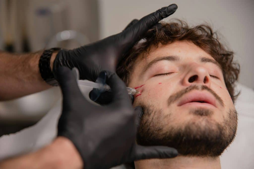 a young man with a beard receiving botox