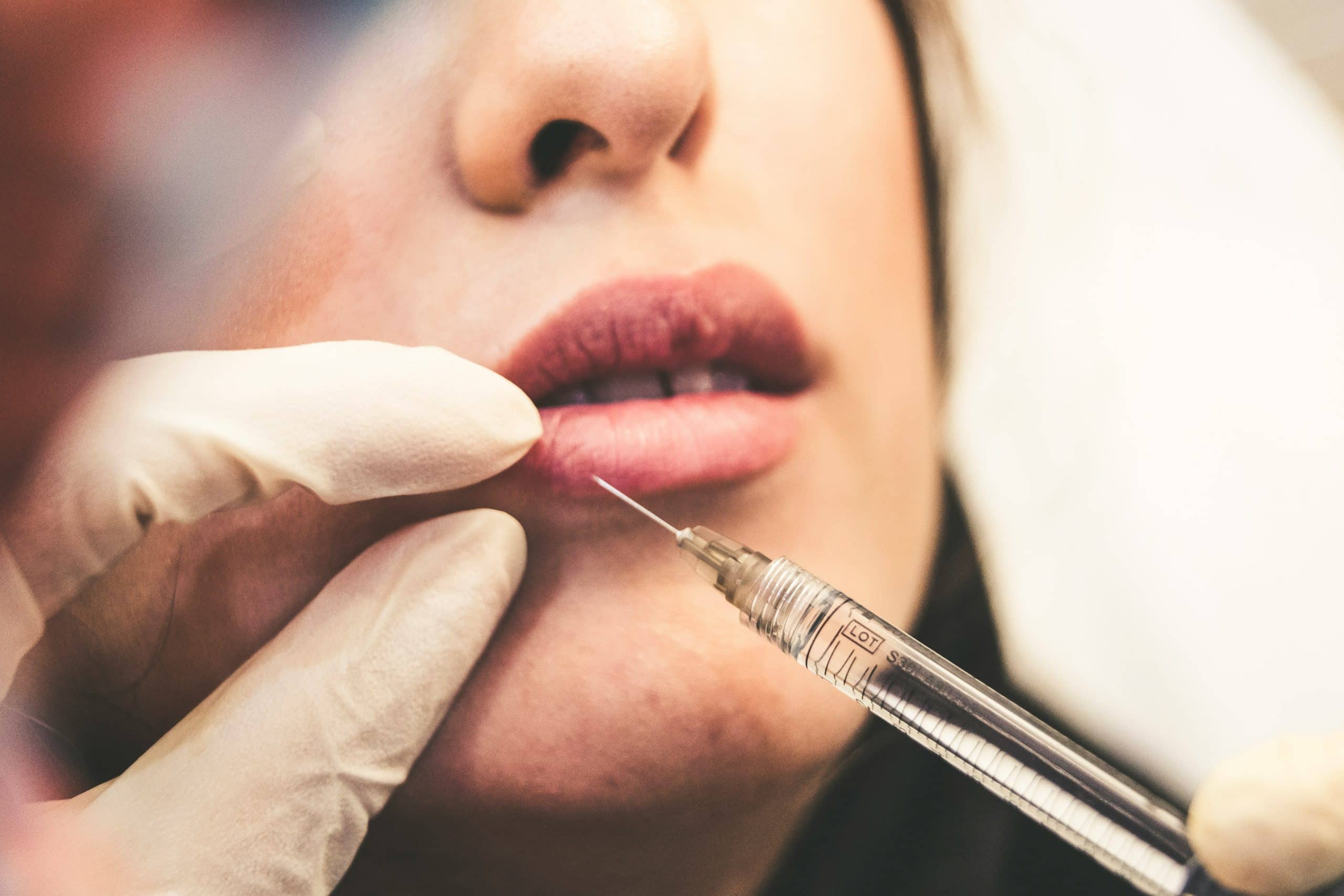 a women getting injected into her lip