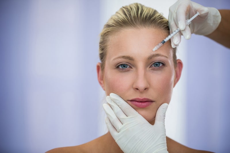 Botox Injection Being Administered To A Patient’s Forehead In A Clinical Aesthetic Treatment Setting
