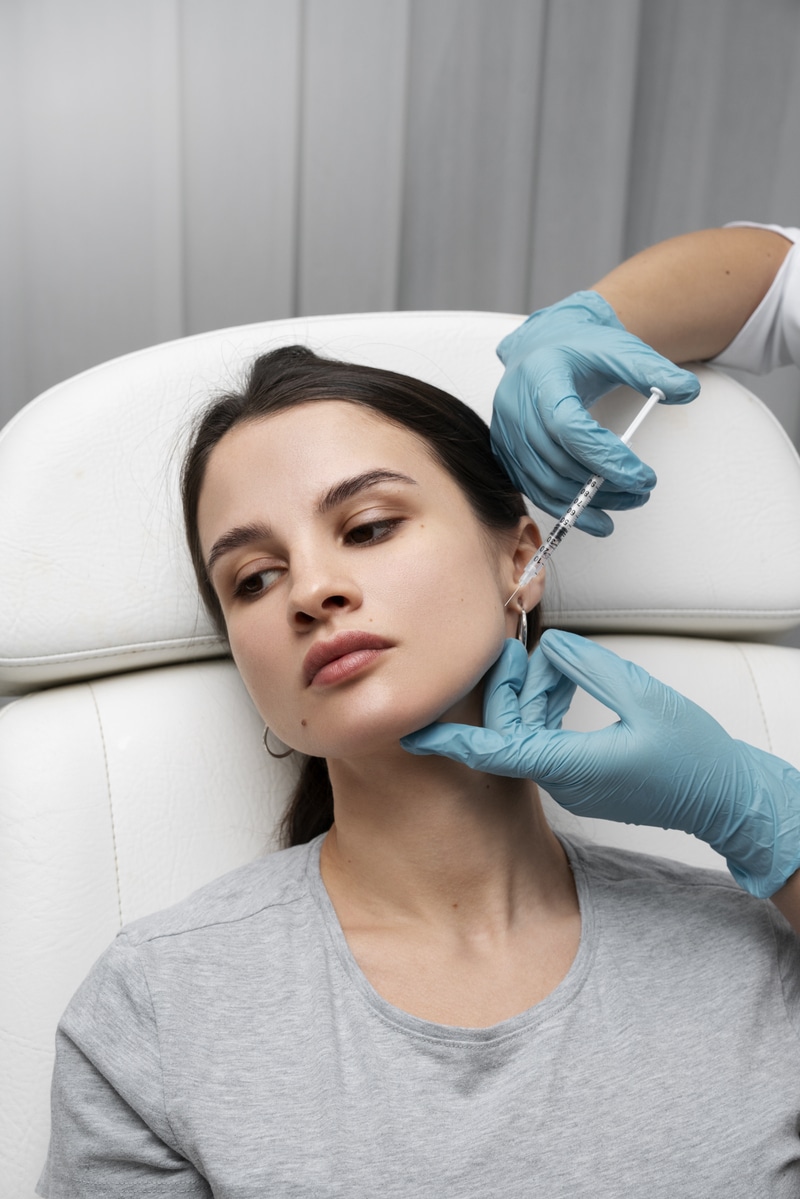 Doctor Giving Woman Masseter Botox Injection High Angle